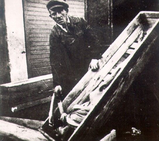 A corpse in a coffin in the Warsaw ghetto